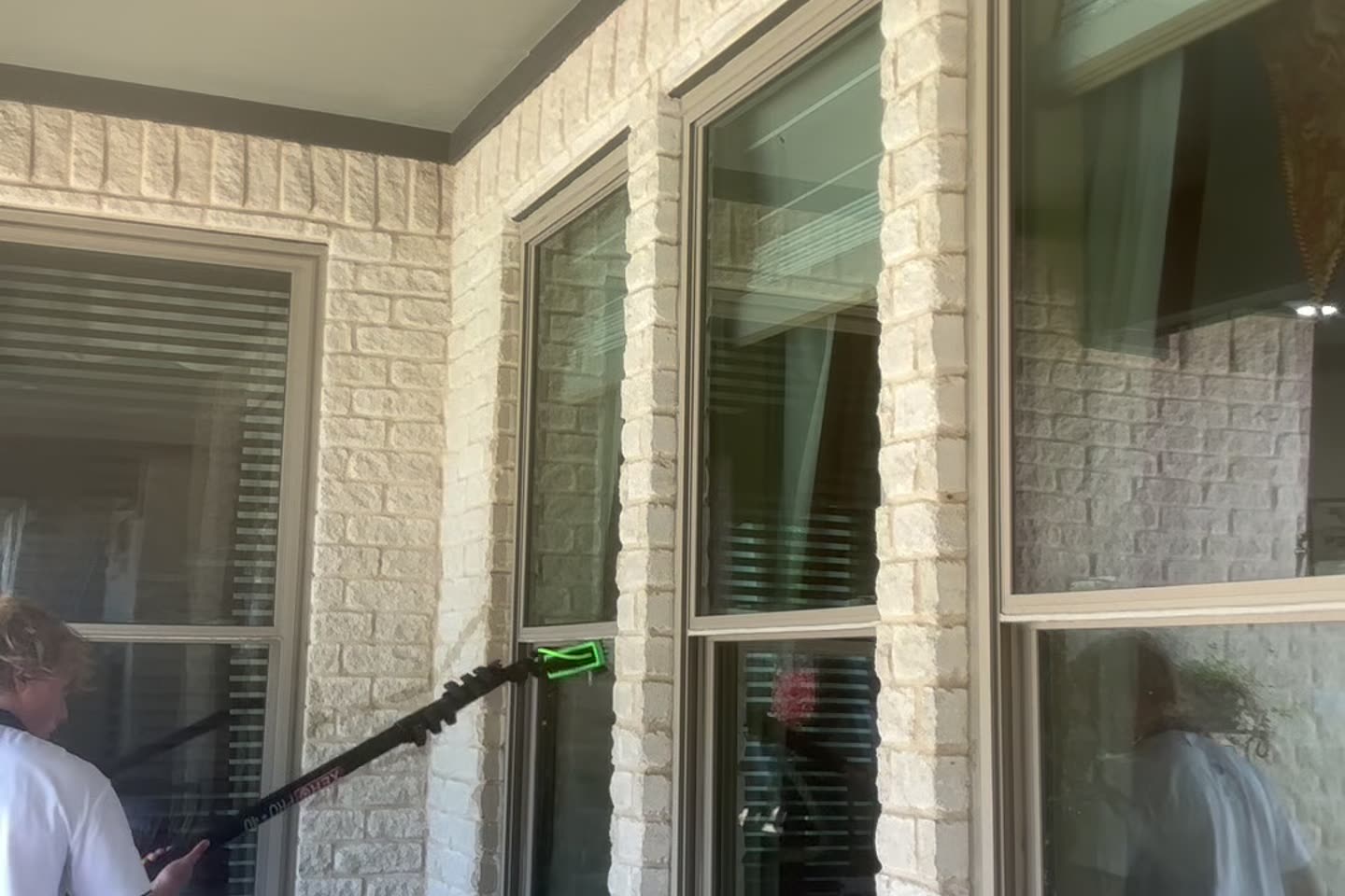 Two-story home exterior after a spring storm, ready for a window cleaning